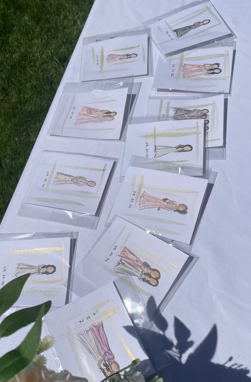 Packaged live guest illustrations arranged at an outdoor celebration